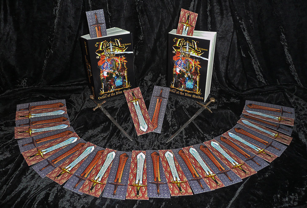 There are a couple of copies of The Tail of the Order of the Blue Maiden with a bunch of bookmarks laid out in front on a velvet background.